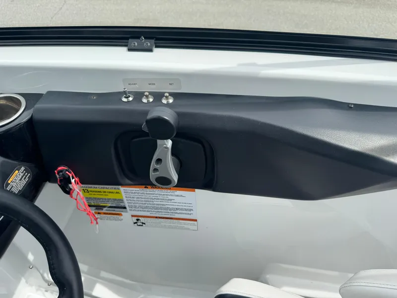 Slide: The Image of 2020 Scarab 255 Open ID boat control panel with throttle and warning labels. - 47