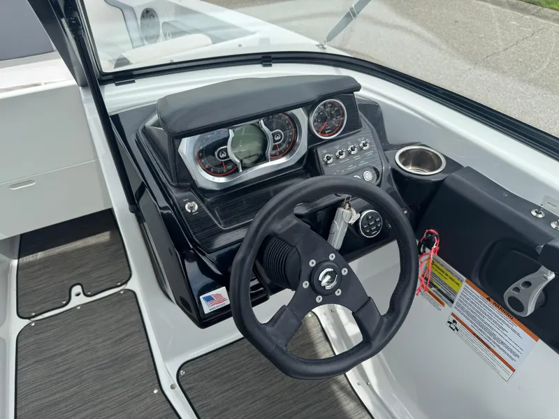 Slide: The Image of 2020 Scarab 255 Open ID boat dashboard with steering wheel and gauges. - 48