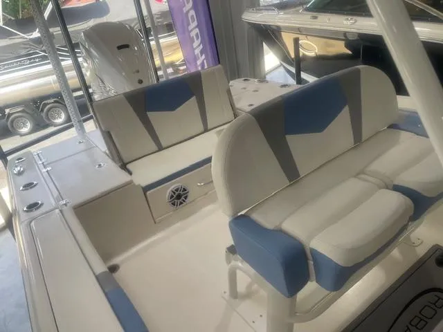 Slide: The Image of 2023 Robalo 266 Cayman boat interior with blue and white seating. - 10