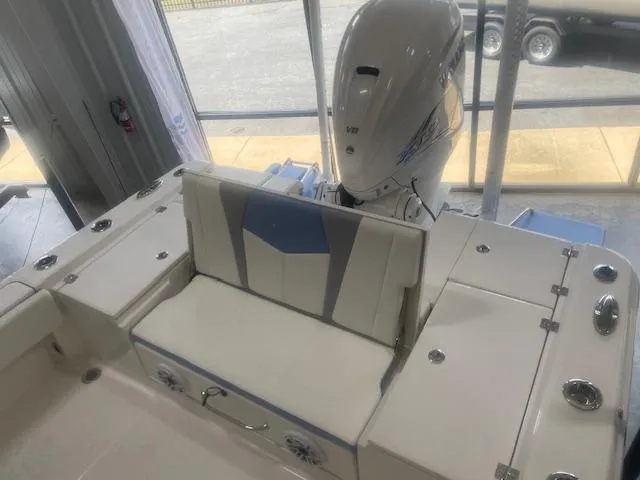 Slide: The Image of 2023 Robalo 266 Cayman boat interior with seating and outboard motor. - 14