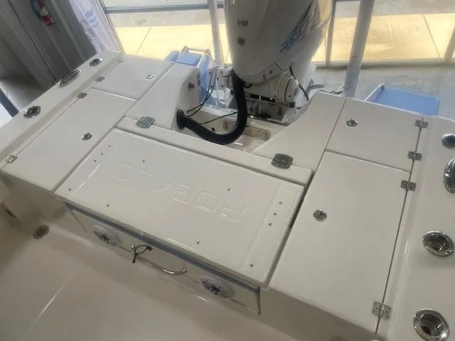 Slide: The Image of 2023 Robalo 266 Cayman boat deck with storage compartments and outboard motor. - 15