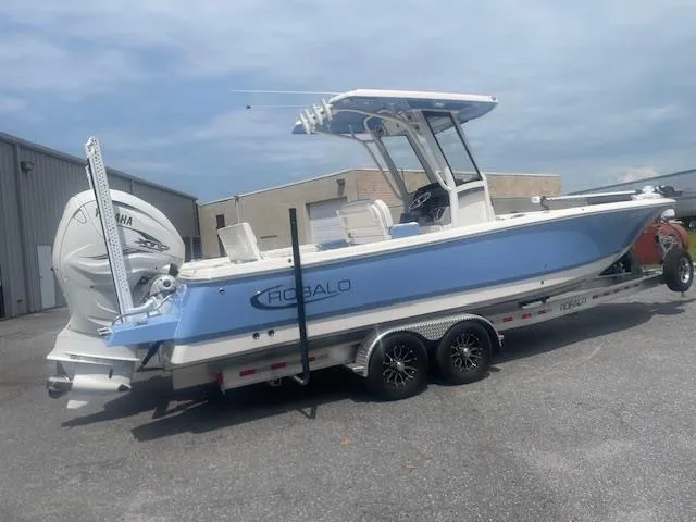 Slide: The Image of 2023 Robalo 266 Cayman boat on trailer, featuring sleek design and Yamaha engine. - 3