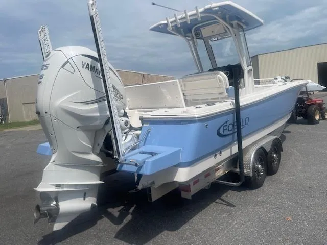 Slide: The Image of 2023 Robalo 266 Cayman boat with Yamaha engine on a trailer, parked outdoors. - 5