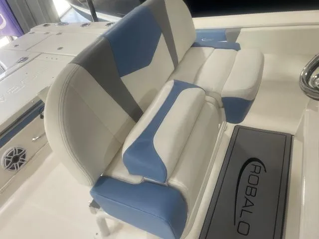 Slide: The Image of 2023 Robalo 266 Cayman boat seat with blue and white upholstery. - 6