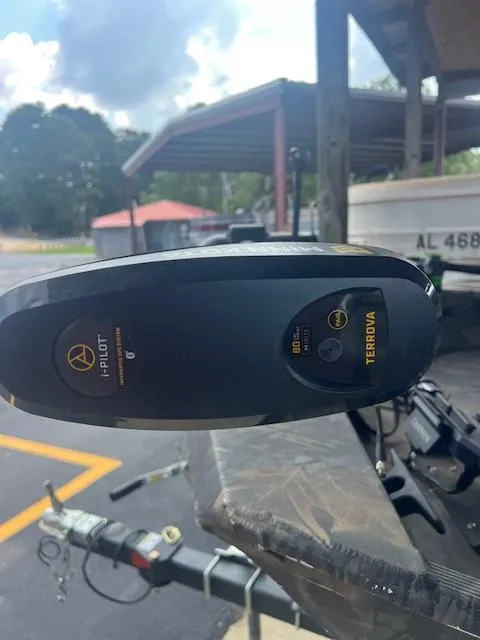 Slide: The Image of 2023 Lowe Roughneck 1860 CC boat with Minn Kota Terrova trolling motor in a parking area. - 3