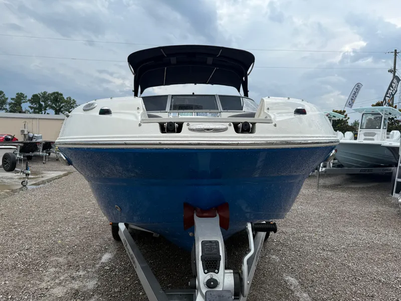 Slide: The Image of 2018 Stingray 214 LR boat on trailer, blue hull, overcast sky background. - 10