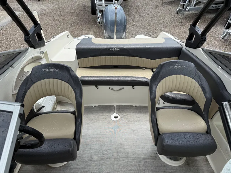 Slide: The Image of 2018 Stingray 214 LR boat interior with two seats and a rear bench. - 14