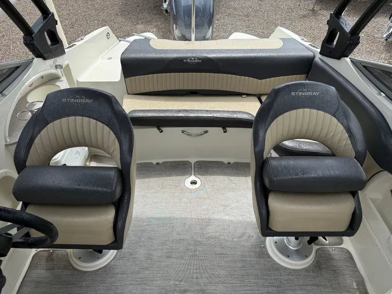 Slide: The Image of 2018 Stingray 214 LR boat interior with dual seats and rear bench. - 16