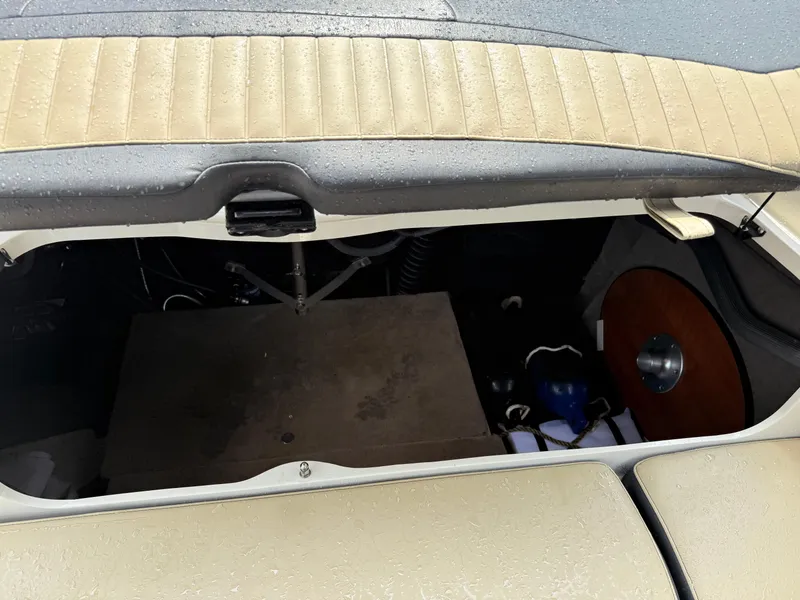 Slide: The Image of Open storage compartment in a 2018 Stingray 214 LR boat, showing interior details. - 20