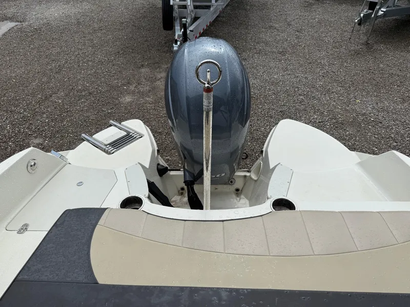 Slide: The Image of 2018 Stingray 214 LR boat rear view with outboard motor and swim platform. - 22