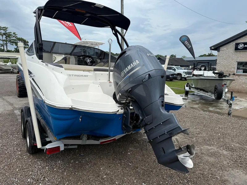 Slide: The Image of 2018 Stingray 214 LR boat with Yamaha outboard motor on a trailer. - 4