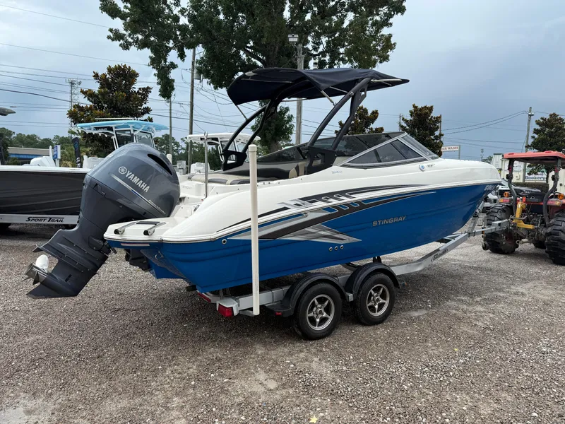 Slide: The Image of 2018 Stingray 214 LR boat with Yamaha outboard motor on a trailer. - 7