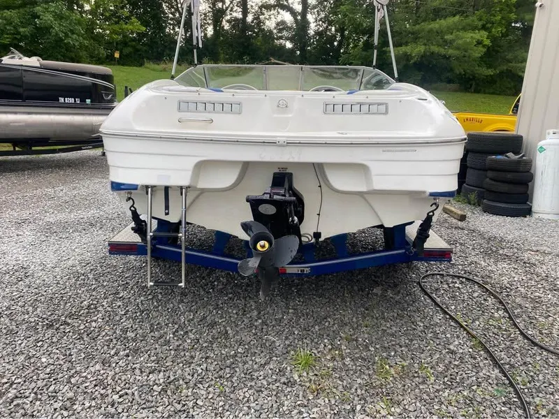 Slide: The Image of 2005 Mariah SX19 boat on trailer, rear view, parked on gravel. - 3