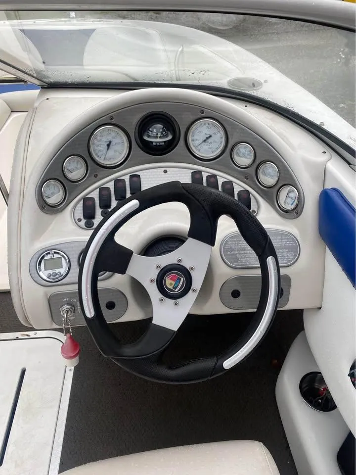 Slide: The Image of Dashboard of a 2005 Mariah SX19 boat with steering wheel and gauges. - 4