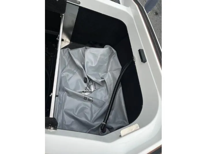 Slide: The Image of 2019 Centurion RI 257 ballast compartment with gray bag and hose. - 12