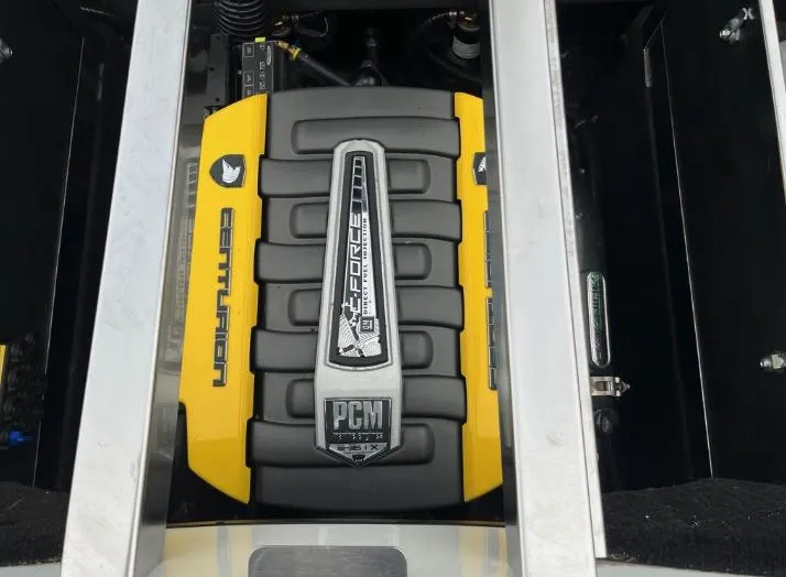 Slide: The Image of Engine of a 2019 Centurion RI 257 boat, featuring PCM branding and yellow accents. - 13
