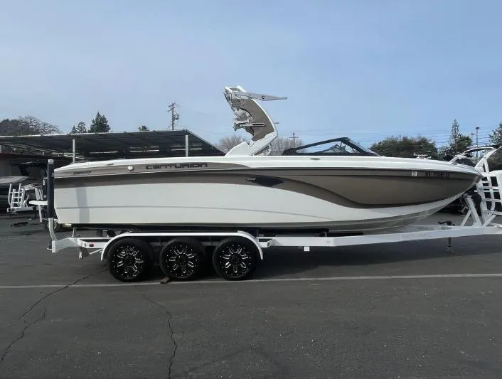 Slide: The Image of 2019 Centurion RI 257 boat on a trailer, parked outdoors. - 18