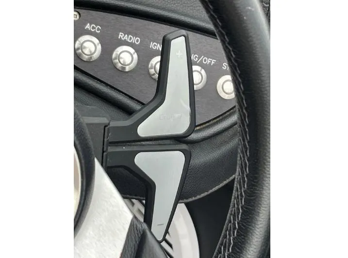 Slide: The Image of Steering wheel with paddle shifters in a 2019 Centurion RI 257 boat. - 25