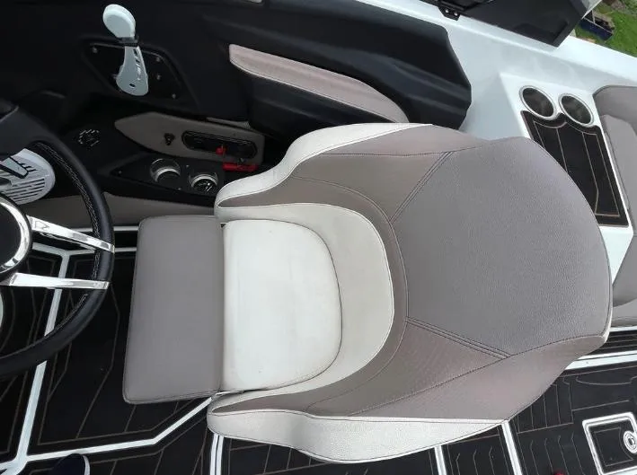 Slide: The Image of 2019 Centurion RI 257 boat interior with steering wheel, seat, and cup holders. - 28