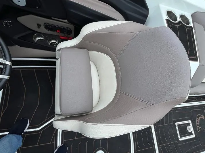 Slide: The Image of 2019 Centurion RI 257 boat interior with gray captain's chair and dashboard controls. - 29