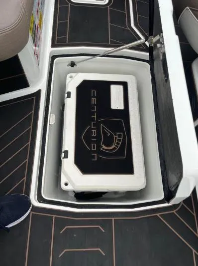 Slide: The Image of 2019 Centurion RI 257 boat storage compartment with branded cover. - 32