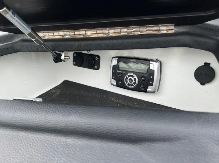 Slide: The Image of 2019 Centurion RI 257 boat dashboard with Clarion audio system and controls. - 34