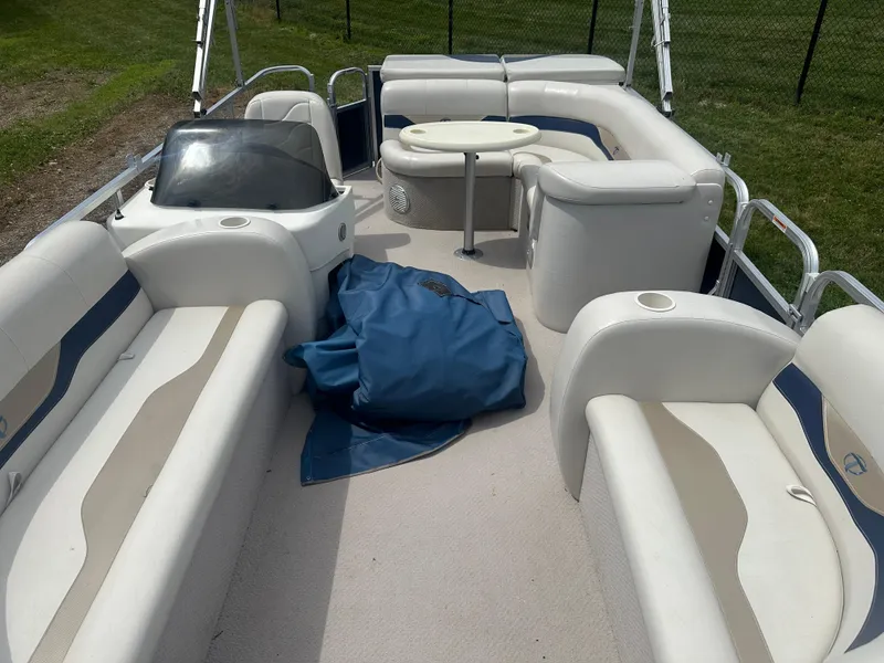 Slide: The Image of 2011 Tahoe LT1900 boat interior with white seating and a small table. - 3
