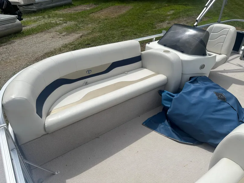 Slide: The Image of 2011 Tahoe LT1900 boat interior with white seating and blue cover. - 5