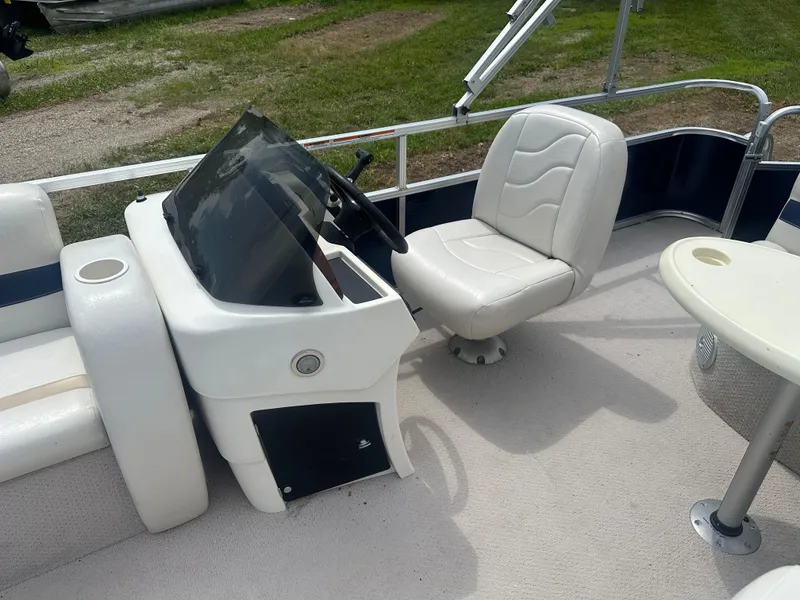 Slide: The Image of 2011 Tahoe LT1900 boat interior with white captain's chair and steering console. - 6