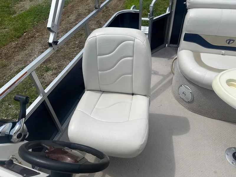 Slide: The Image of 2011 Tahoe LT1900 boat interior with white captain's chair and steering wheel. - 7