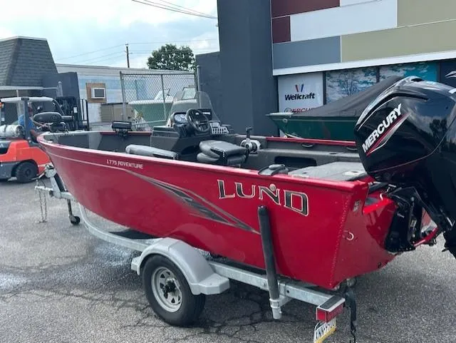 Slide: The Image of 2022 Lund 1775 Adventure SS boat with Mercury engine on trailer, parked outdoors. - 3