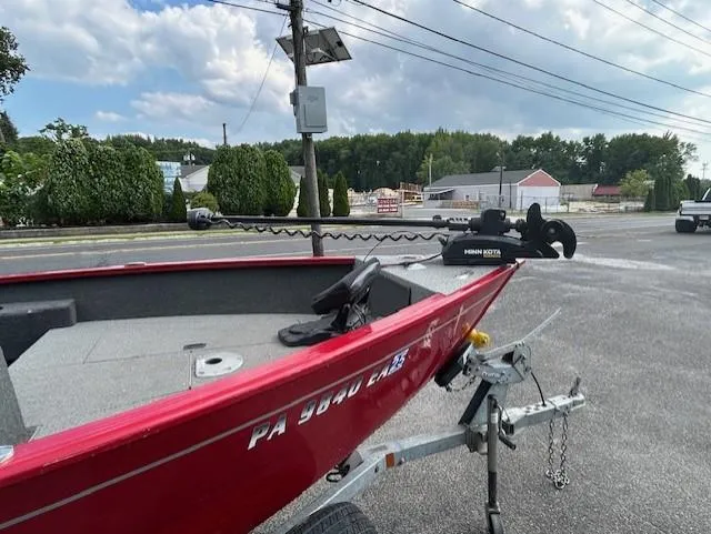 Slide: The Image of 2022 Lund 1775 Adventure SS boat on trailer, red exterior, parked outdoors. - 8