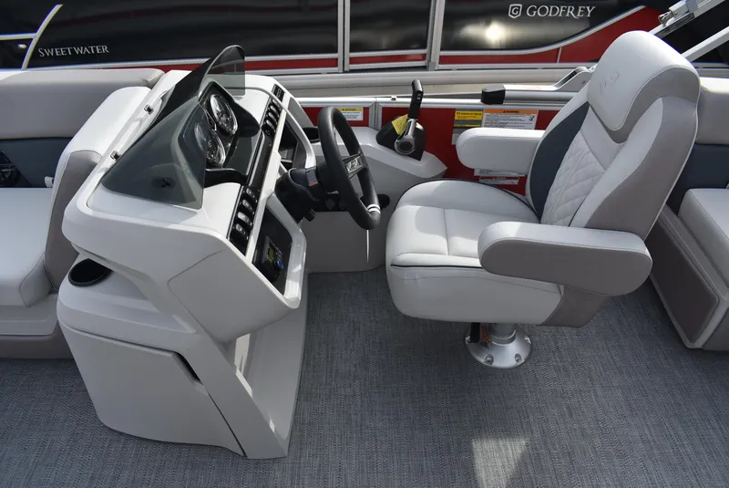 Slide: The Image of 2025 Godfrey Sweetwater 2086 SB boat helm with modern controls and comfortable seating. - 11