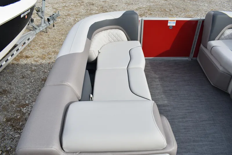 Slide: The Image of 2025 Godfrey Sweetwater 2086 SB boat interior with gray seating and red panel. - 15