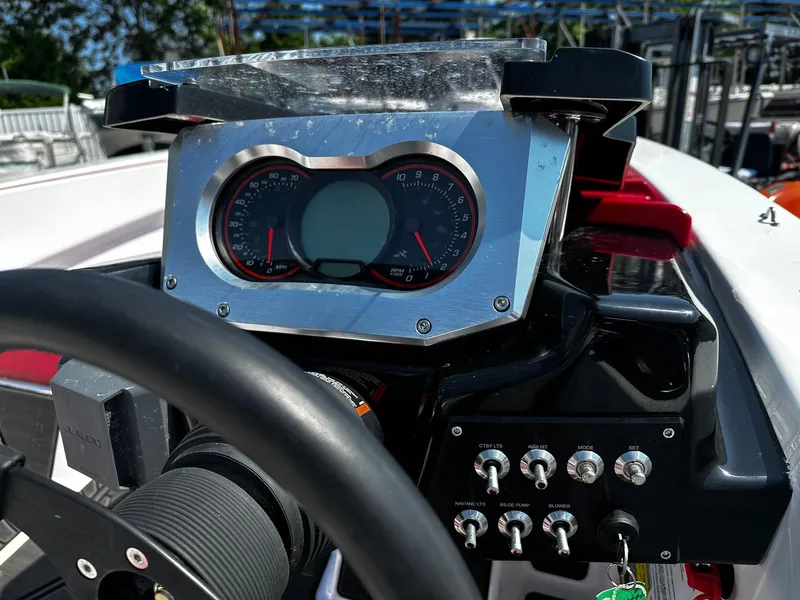 Slide: The Image of Dashboard of a 2023 Scarab 165ID Jet Boat with gauges and control switches. - 4