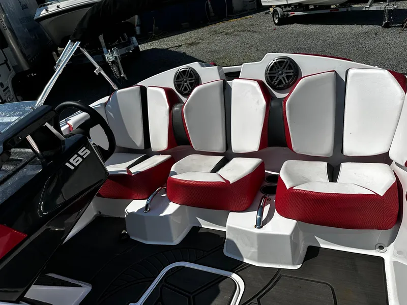 Slide: The Image of 2023 Scarab 165ID Jet Boat interior with red and white seating and speaker system. - 5