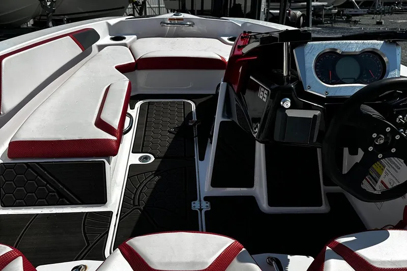 Slide: The Image of 2023 Scarab 165ID Jet Boat interior with red and white seating, modern dashboard, and sleek design. - 7