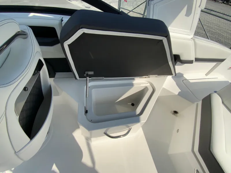Slide: The Image of 2026 Cobalt R4 OB boat interior with open storage compartment and sleek seating design. - 15
