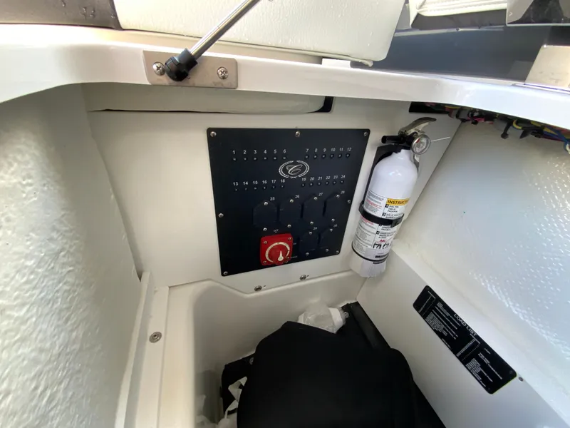 Slide: The Image of Control panel and fire extinguisher in 2026 Cobalt R4 OB boat interior. - 20