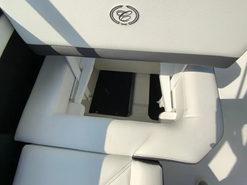 Slide: The Image of 2026 Cobalt R4 OB boat seat storage compartment with logo. - 23