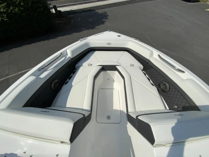 Slide: The Image of 2026 Cobalt R4 OB boat interior with white cushioned seating and sleek design. - 25