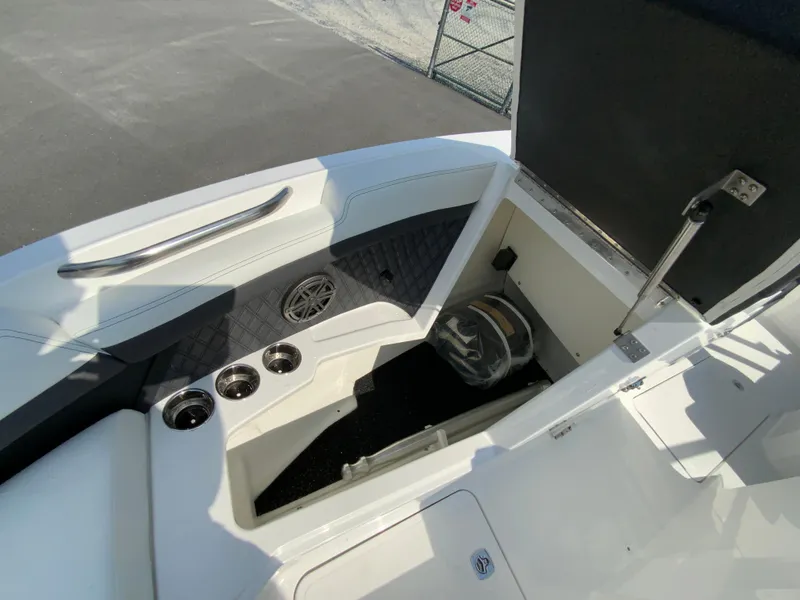 Slide: The Image of 2026 Cobalt R4 OB boat interior with storage compartment and cup holders. - 27