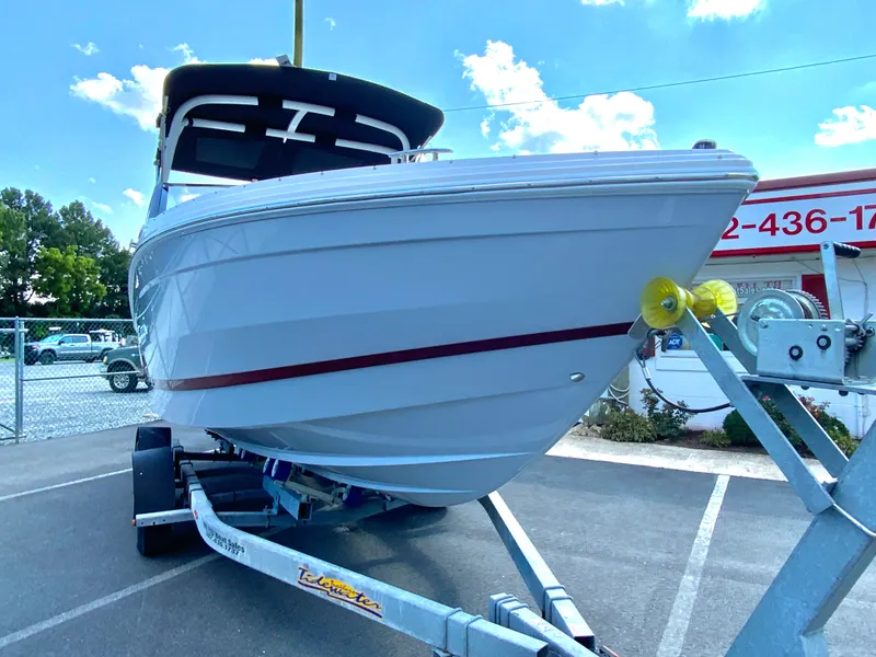 Slide: The Image of 2026 Cobalt R4 OB boat on trailer, parked outdoors under a clear sky. - 3