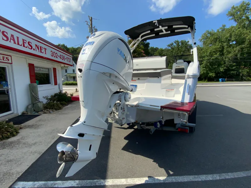 Slide: The Image of 2026 Cobalt R4 OB boat with outboard motor, parked outside a sales building. - 9