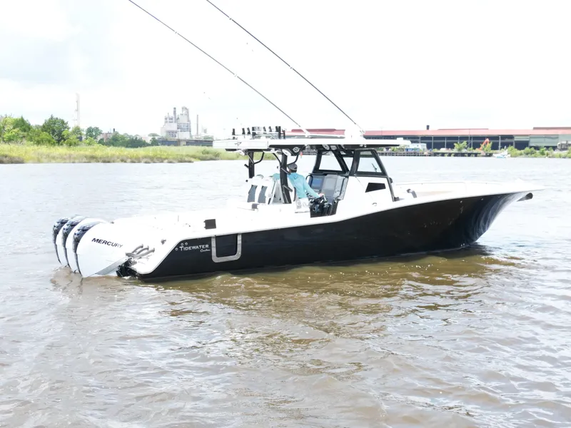 Slide: The Image of 2023 Tidewater 380 CC Adventure boat seating area with modern design and cup holders. - 10