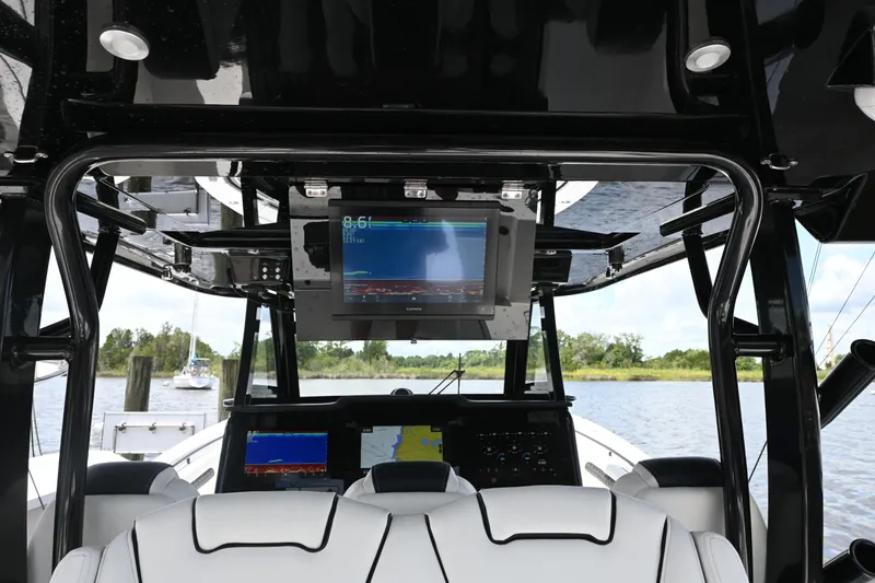 Slide: The Image of 2023 Tidewater 380 CC Adventure boat docked, featuring sleek design and modern equipment. - 15