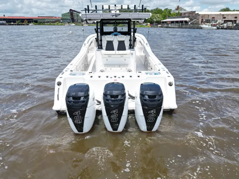 Slide: The Image of 2023 Tidewater 380 CC Adventure boat with triple 400 horsepower engines on water. - 3