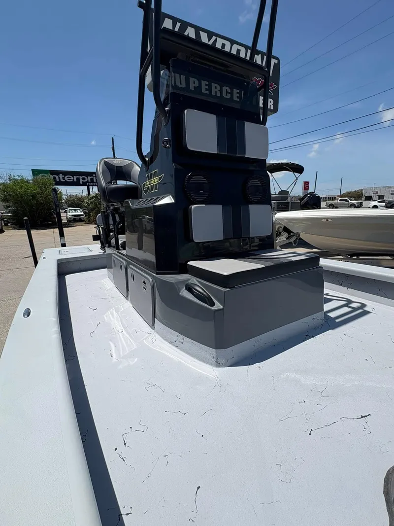 Slide: The Image of 2022 JH Performance Outlaw 250 boat, sleek design, parked outdoors under clear sky. - 10