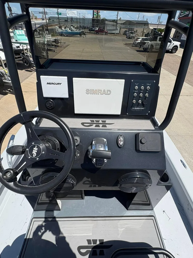 Slide: The Image of 2022 JH Performance Outlaw 250 boat dashboard with Simrad and Mercury controls. - 12