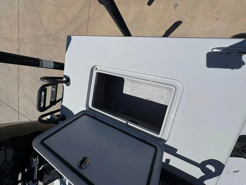 Slide: The Image of 2022 JH Performance Outlaw 250 boat storage compartment with open lid, showing interior space. - 14